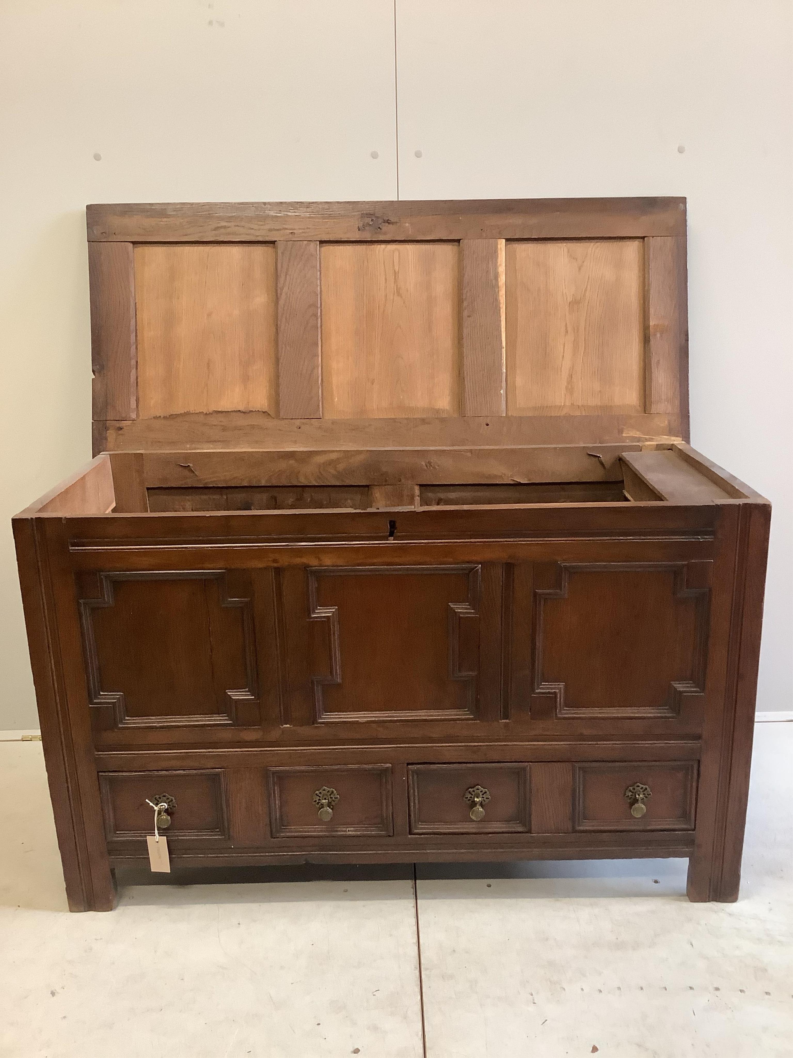 An 18th century panelled oak mule chest, width 126cm, depth 54cm, height 76cm. Condition - fair